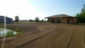 Greeneris darbuotojų suvoluota ir išlyginta augavietės dirva prieš vejos sėjimą.